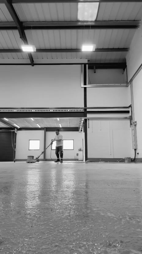 Luke operating a floor grinder in a large indoor space