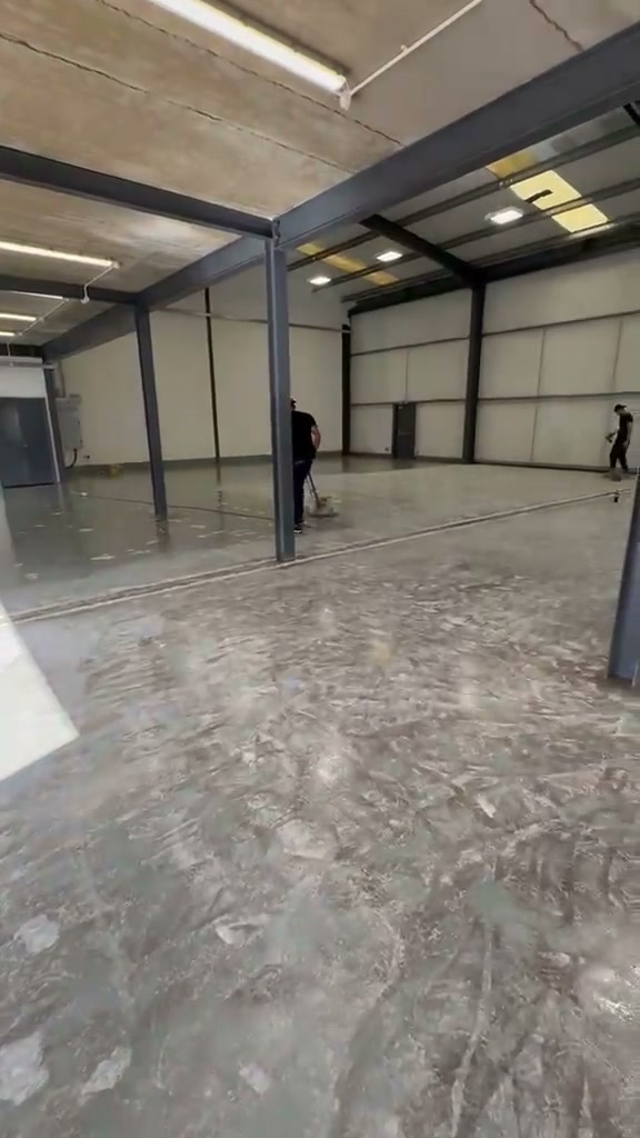 The team preparing the floor inside a large warehouse