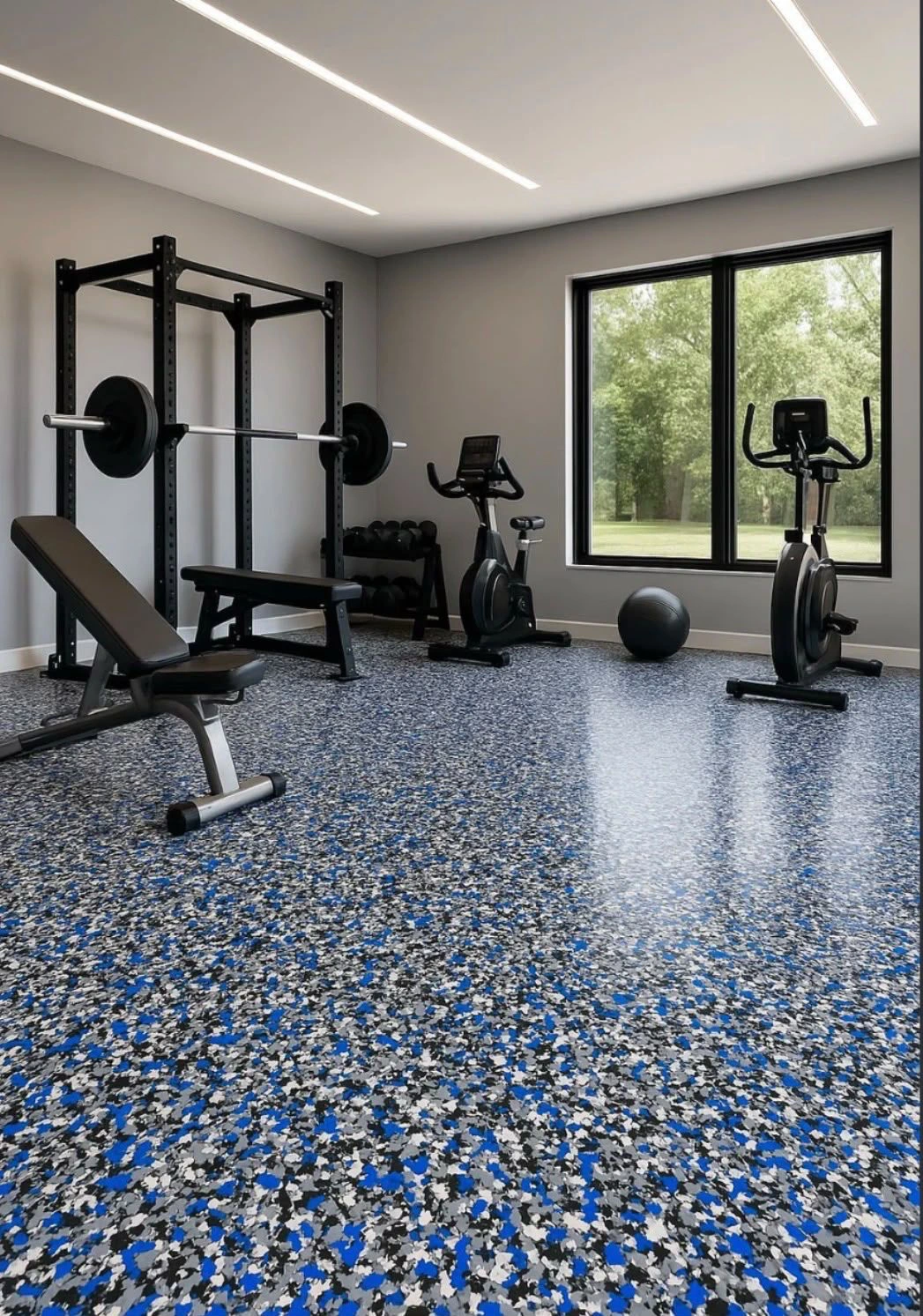 A bright gym with a blue, grey and white flake floor