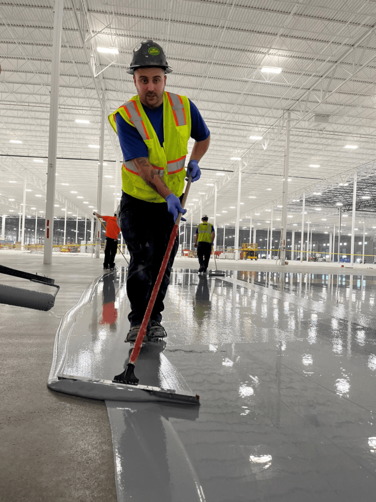 FloorFusion flooring specialist standing on a completed epoxy resin floor